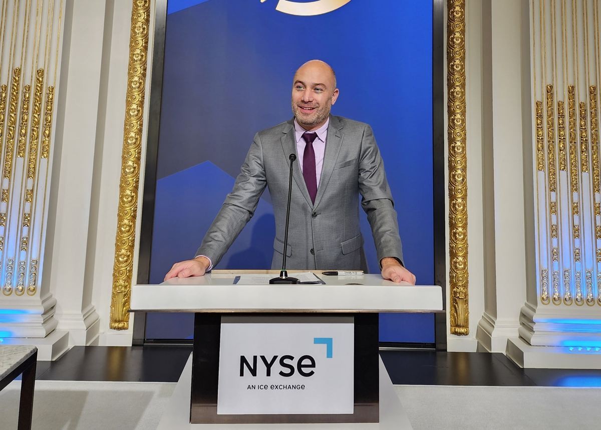 Manny speaking at an NYSE podium