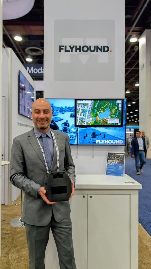 Manny holding the Flyhound payload at AUVSI's Xponential event